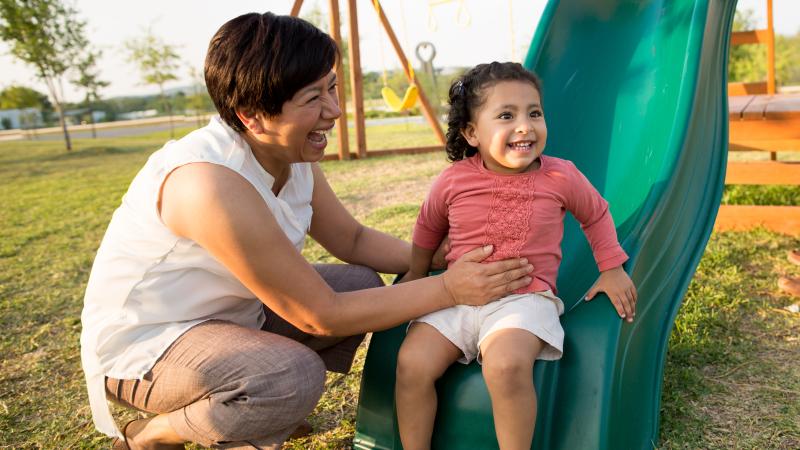 grandmother with kid on slide